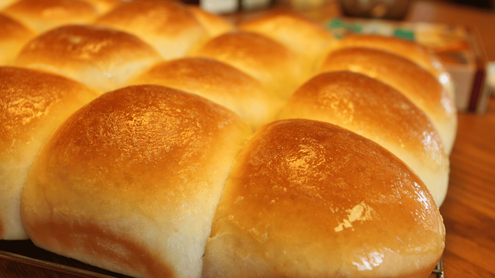 Close up of baked dinner rolls glazed with butter