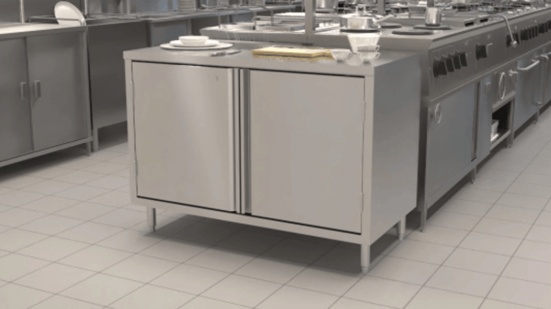 View in a commercial kitchen with BK Resources stainless steel cabinet at the end of ovens and other equipment.