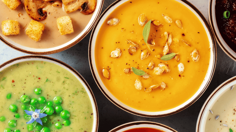 Overview of bowls of soup, including mushroom, pumpkin, and split pea. 