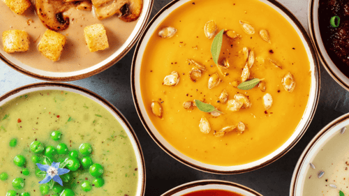 Overview of bowls of smooth soup, including pumpkin, mushroom, and split pea